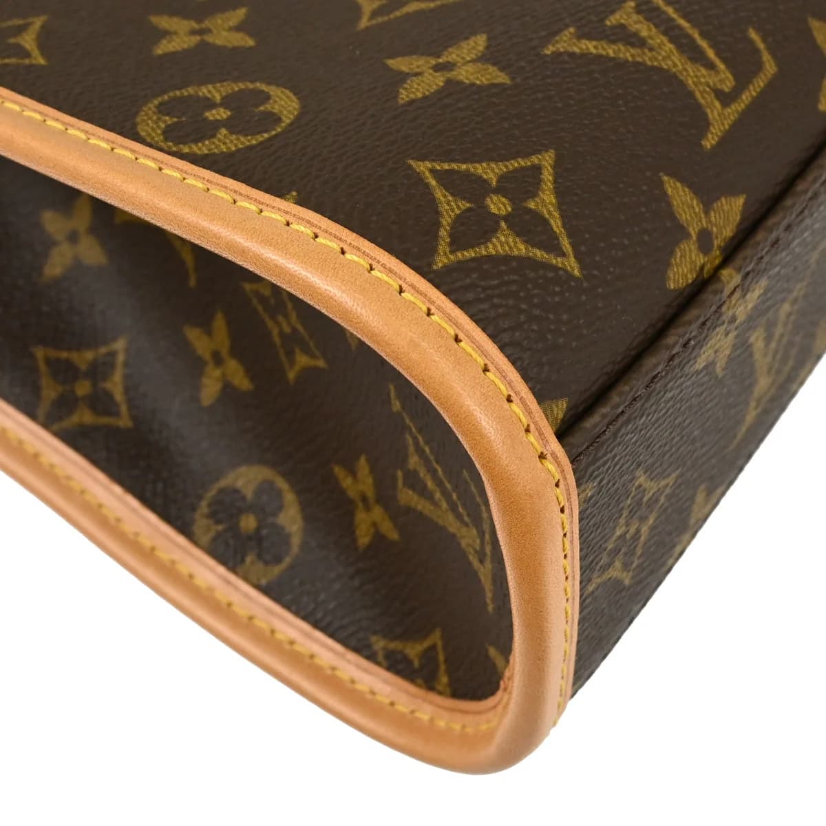Structured brown monogram canvas handbag with leather trim, top handles and a front flap closure.
