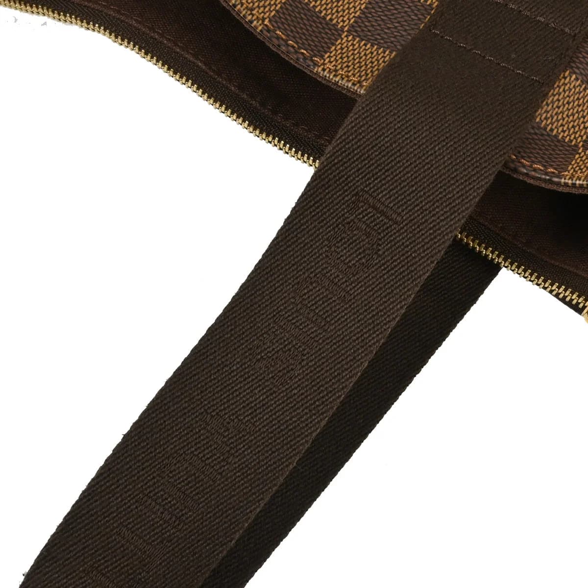 Brown checked canvas tote bag with tan leather handles and trim, standing upright.