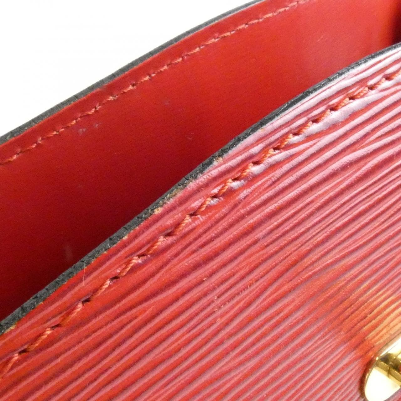 Textured leather flap shoulder bag with a slim strap and buckle closure.