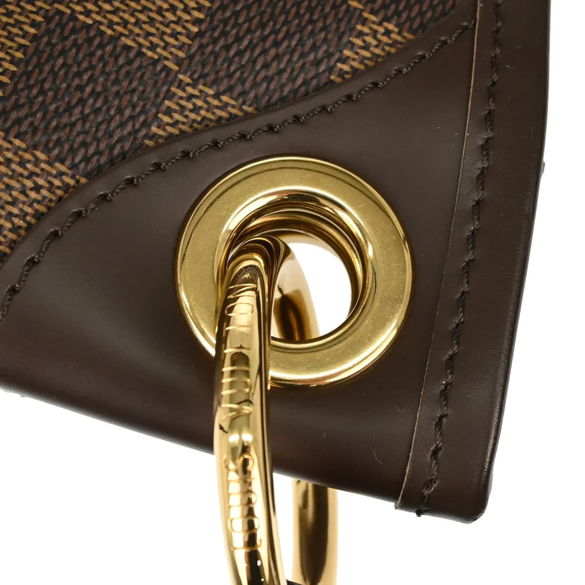 Brown checkered canvas hobo bag with a wide shoulder strap and leather trim