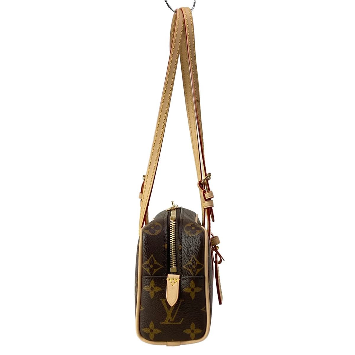 Compact patterned canvas shoulder bag with a flap front and slim strap