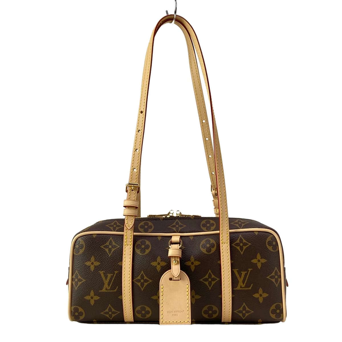 Compact patterned canvas shoulder bag with a flap front and slim strap