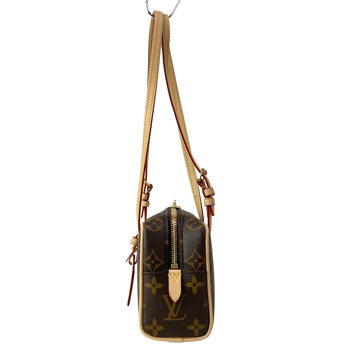 Compact patterned canvas shoulder bag with a flap front and slim strap