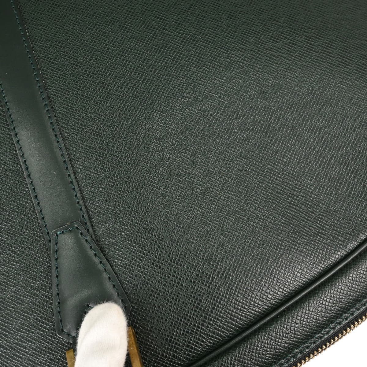 Dark green grained leather travel holdall with twin handles and a zip top