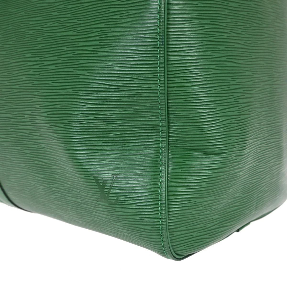 Green textured leather duffle bag with twin handles and a long zip closure.