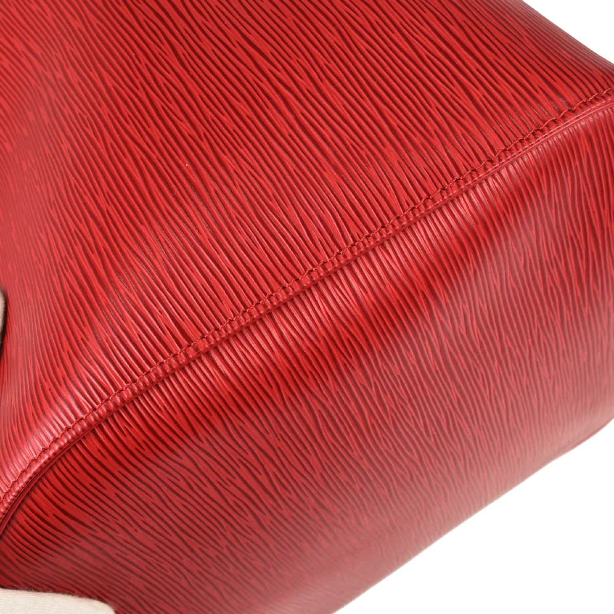 Red textured leather duffle bag with twin handles and a zip top.