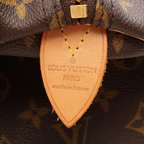 Brown monogram-canvas duffel bag with rolled leather handles and zip top.