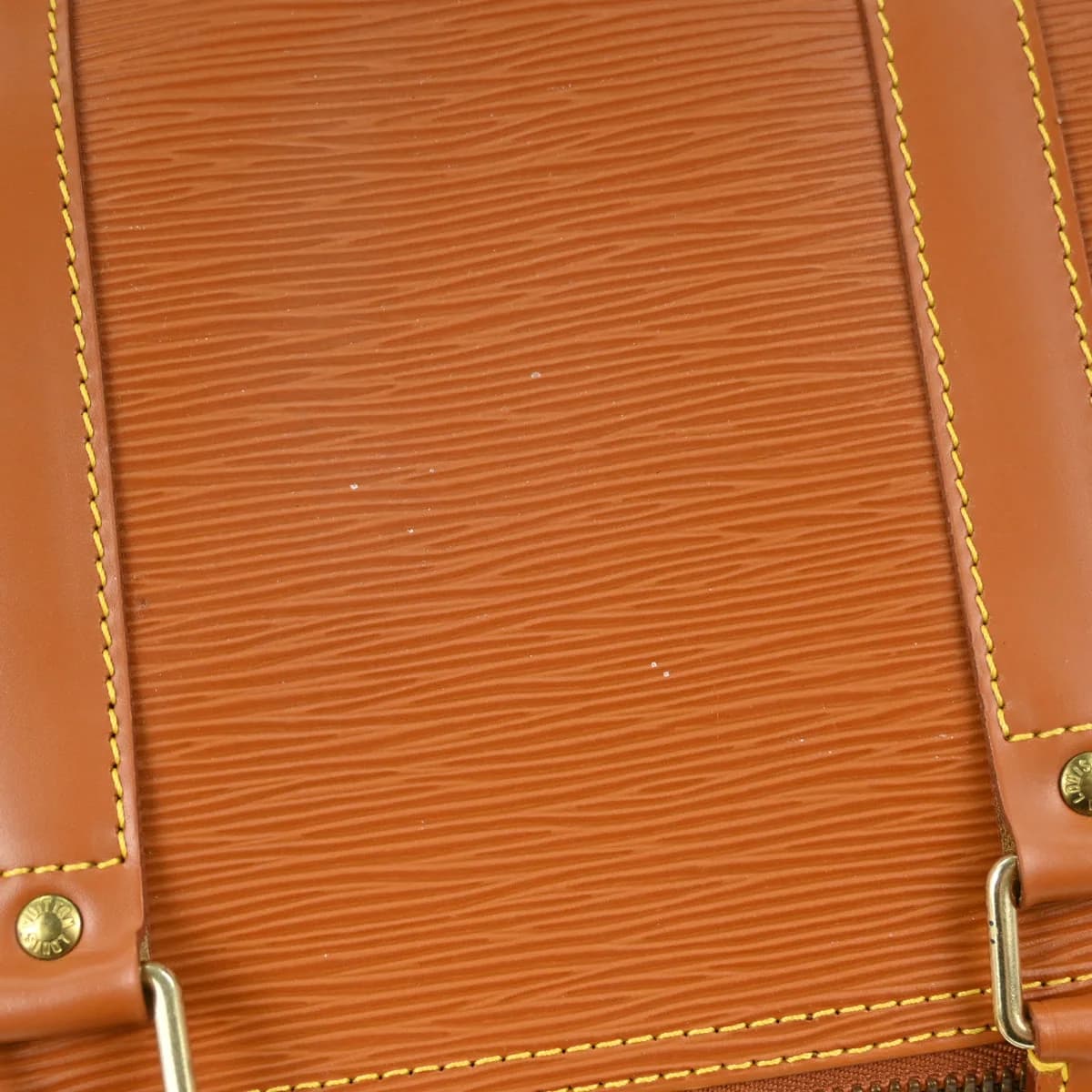 Brown textured leather holdall with twin handles, zip top and side pocket.