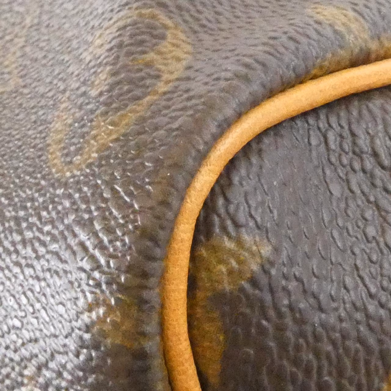 Brown monogram-canvas duffle bag with leather handles and trim.