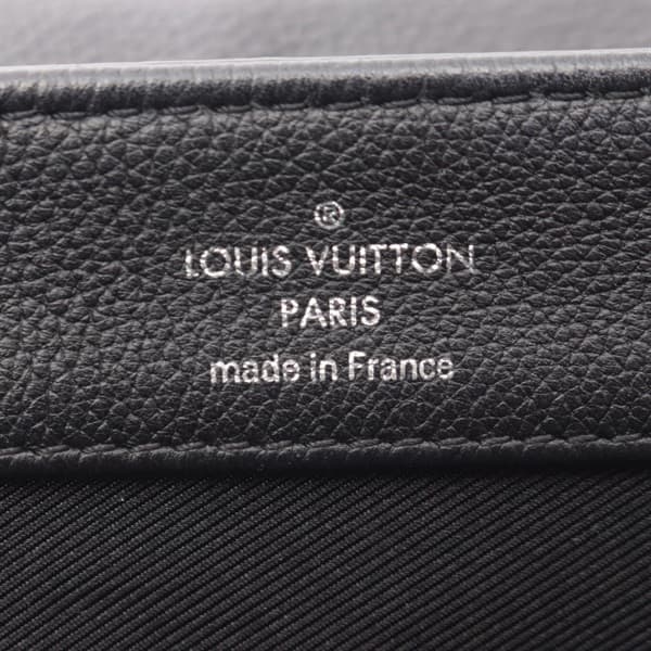 Compact black leather handbag with top handle and silver-tone twist lock.