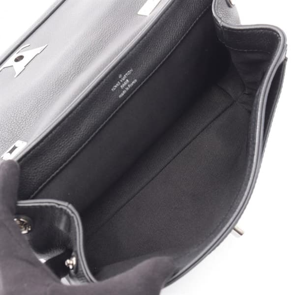 Compact black leather handbag with top handle and silver-tone twist lock.