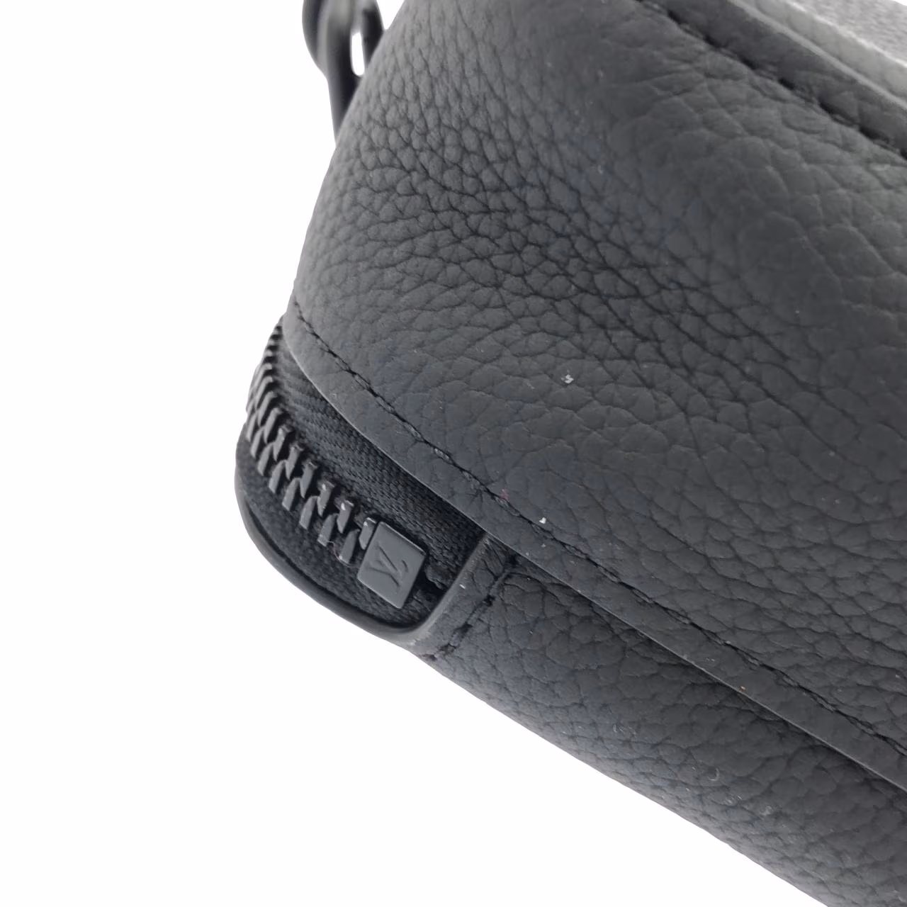 Flat black leather pouch with embossed lettering and a detachable strap.