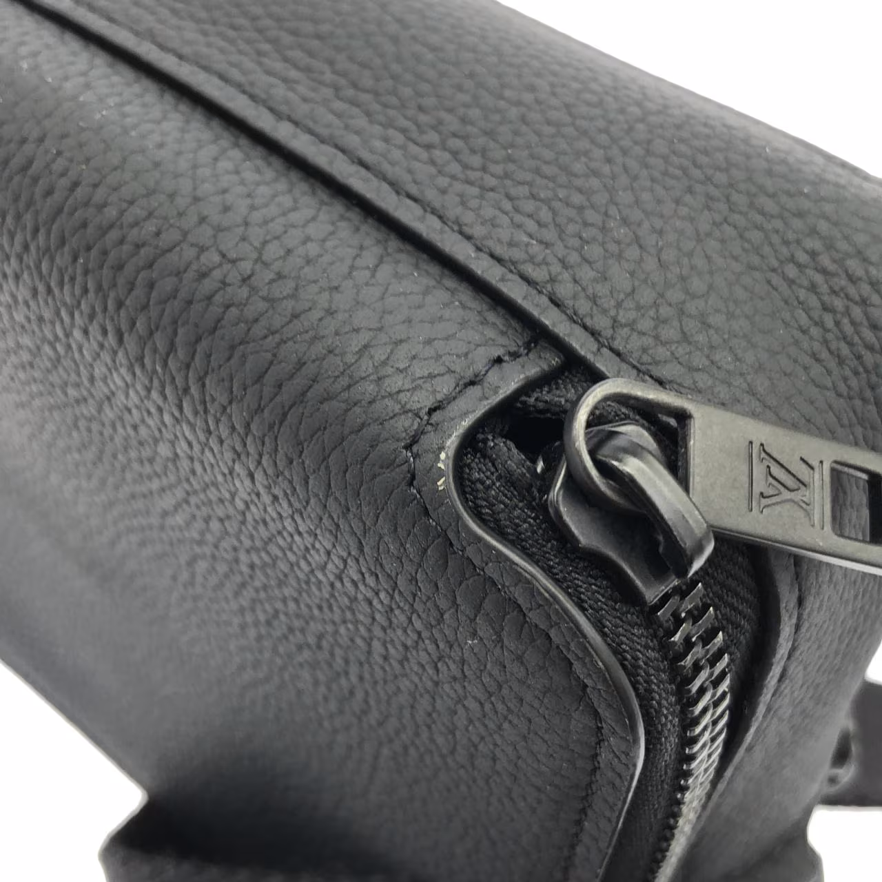 Flat black leather pouch with embossed lettering and a detachable strap.