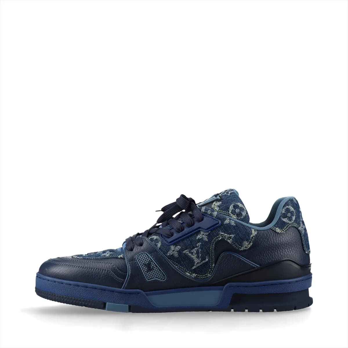 Product photograph of a pair of white and navy high-cut shoes with denim panels and a hanging charm.