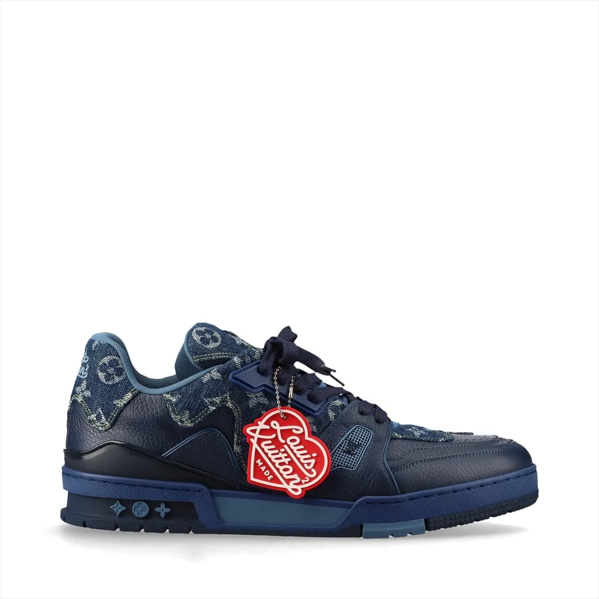 Product photograph of a pair of white and navy high-cut shoes with denim panels and a hanging charm.