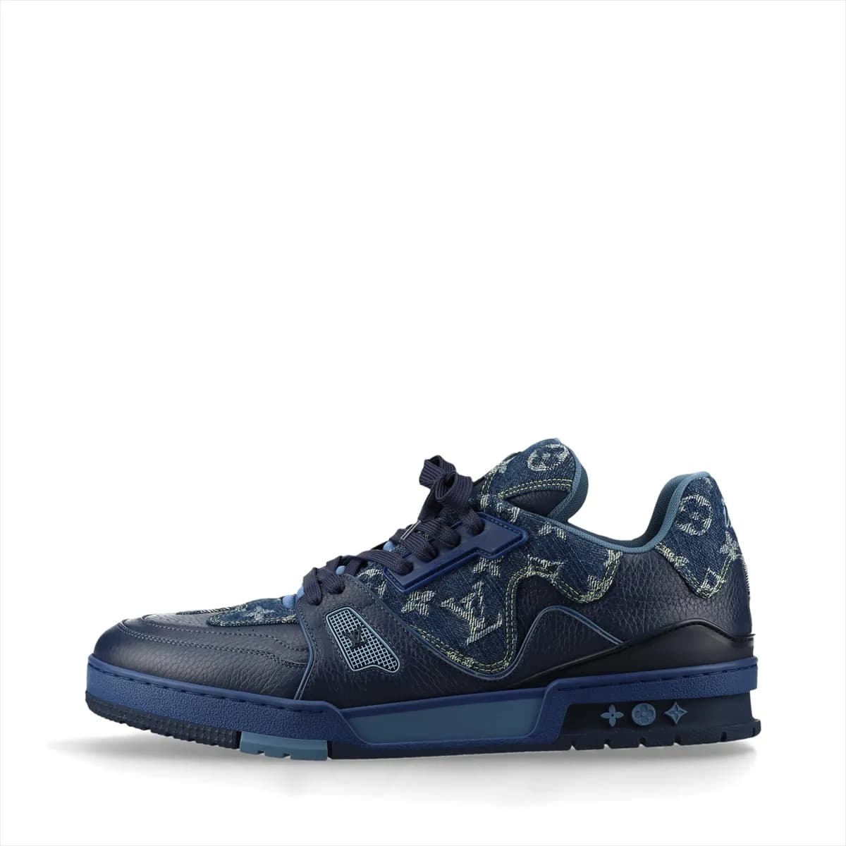 Product photograph of a pair of white and navy high-cut shoes with denim panels and a hanging charm.