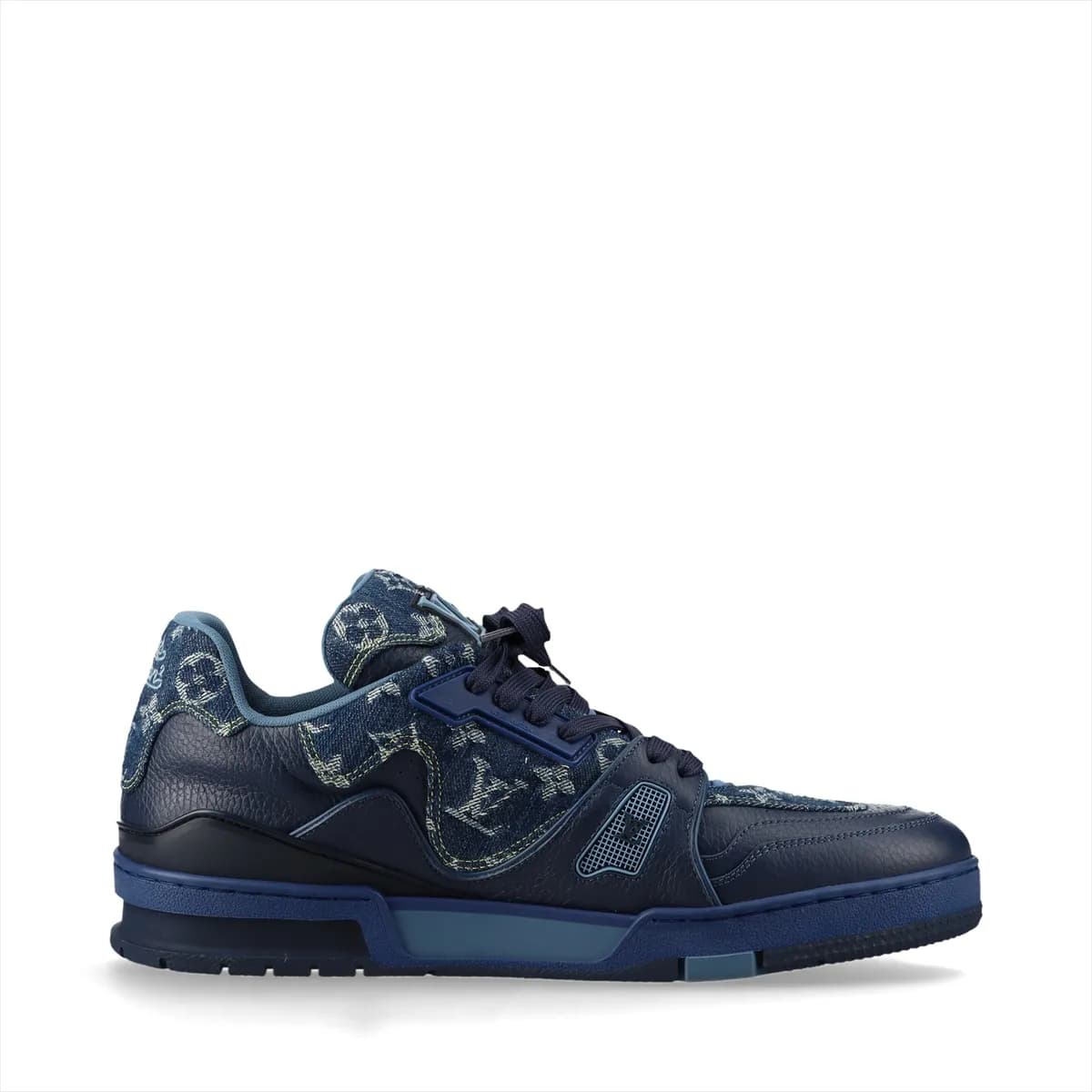 Product photograph of a pair of white and navy high-cut shoes with denim panels and a hanging charm.