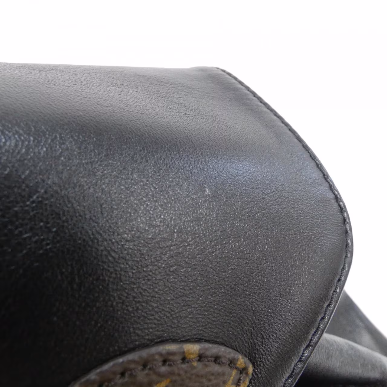 Monogram-patterned backpack with a fluffy textured finish and twin shoulder straps.