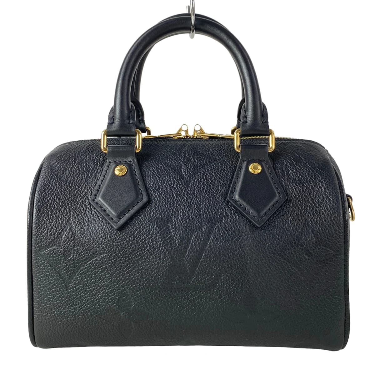 Embossed monogram leather handbag with top handles and a structured body.
