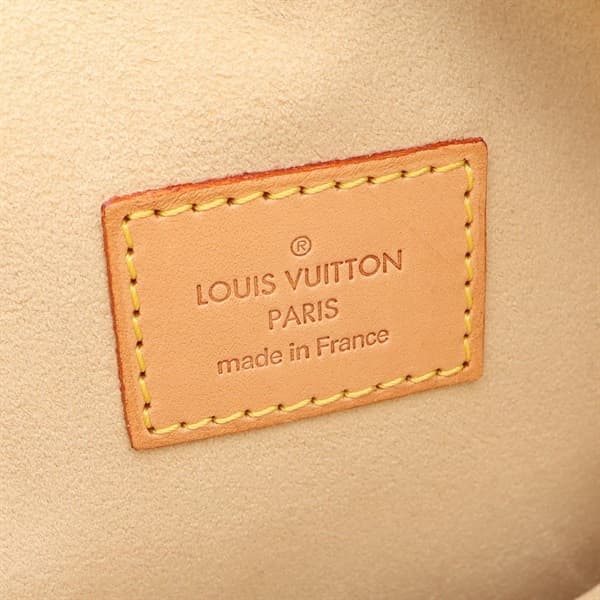 Structured brown monogram-pattern coated canvas handbag with twin leather handles and metal clasps.