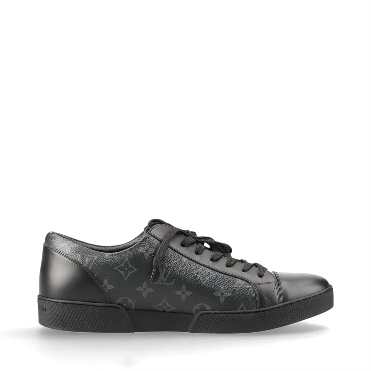 Black monogram-patterned low-top footwear with leather panels and a white sole