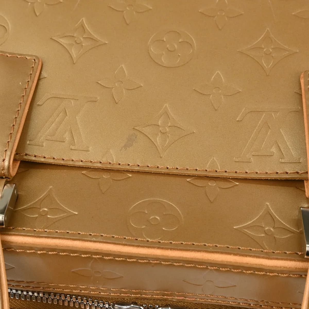 Embossed monogram leather handbag in pale gold with two short handles