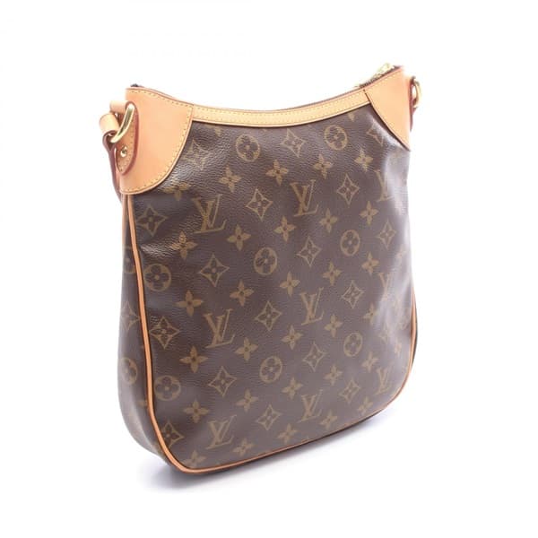 Brown monogram-pattern coated canvas flap crossbody bag with a wide adjustable strap.