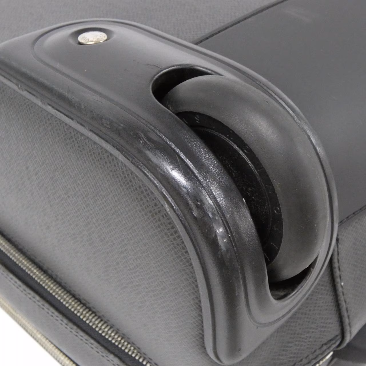 Rigid grained leather briefcase-style travel case with a top handle