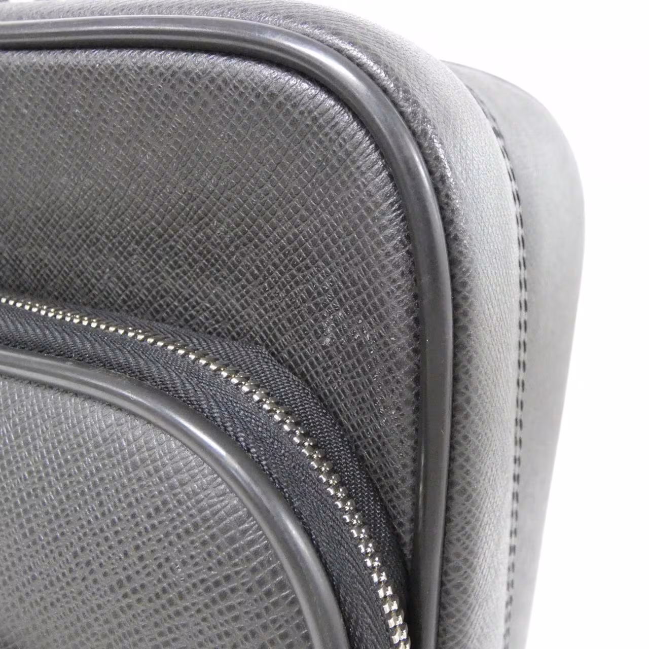 Rigid grained leather briefcase-style travel case with a top handle