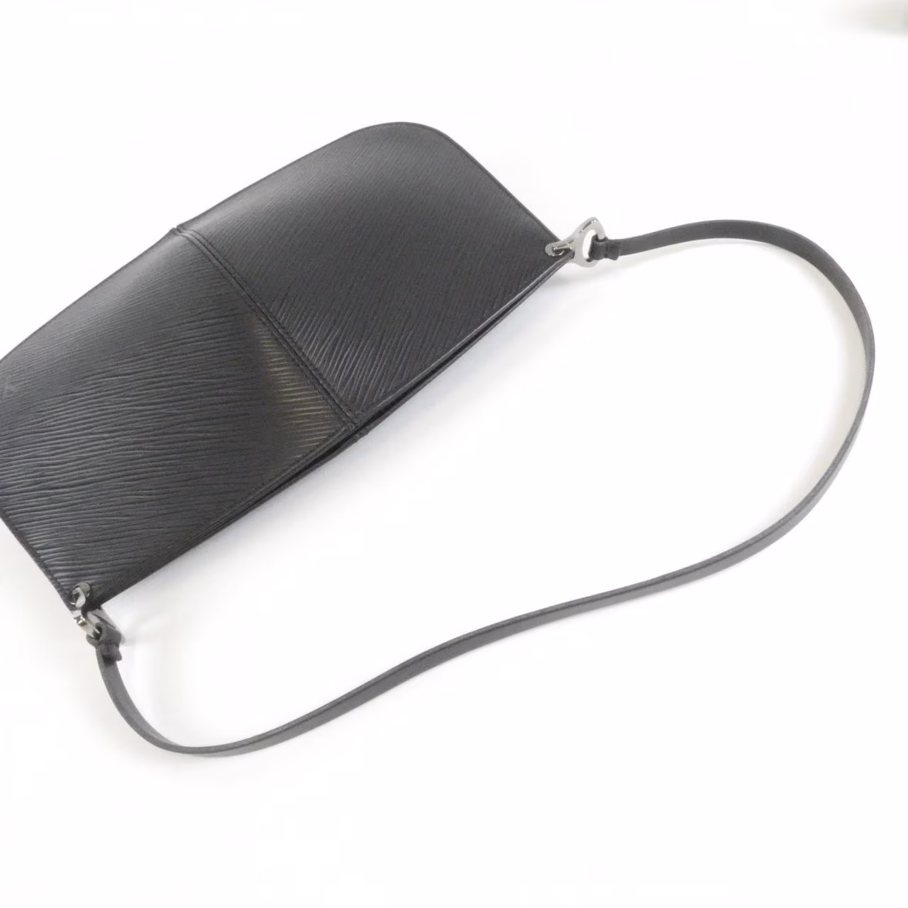 Half-moon shaped textured leather pouch with a zip top.