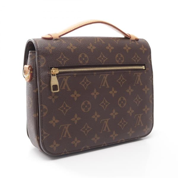 Product photograph of a structured monogram-canvas flap bag with a top handle.