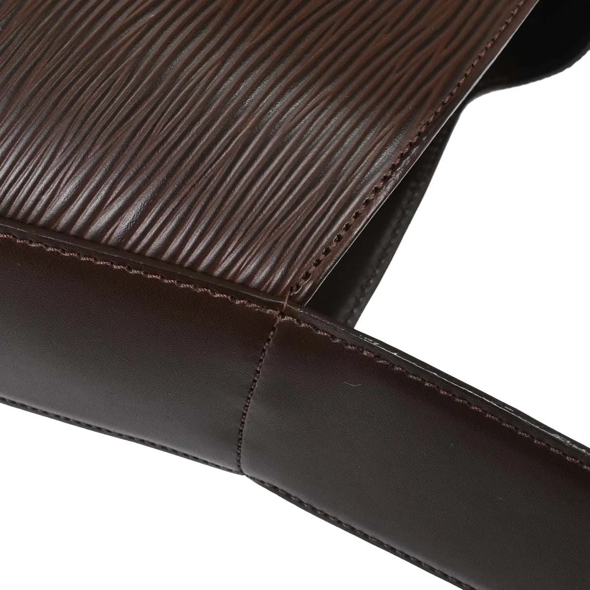 Brown textured leather shoulder bag with a slim strap and a flap front.