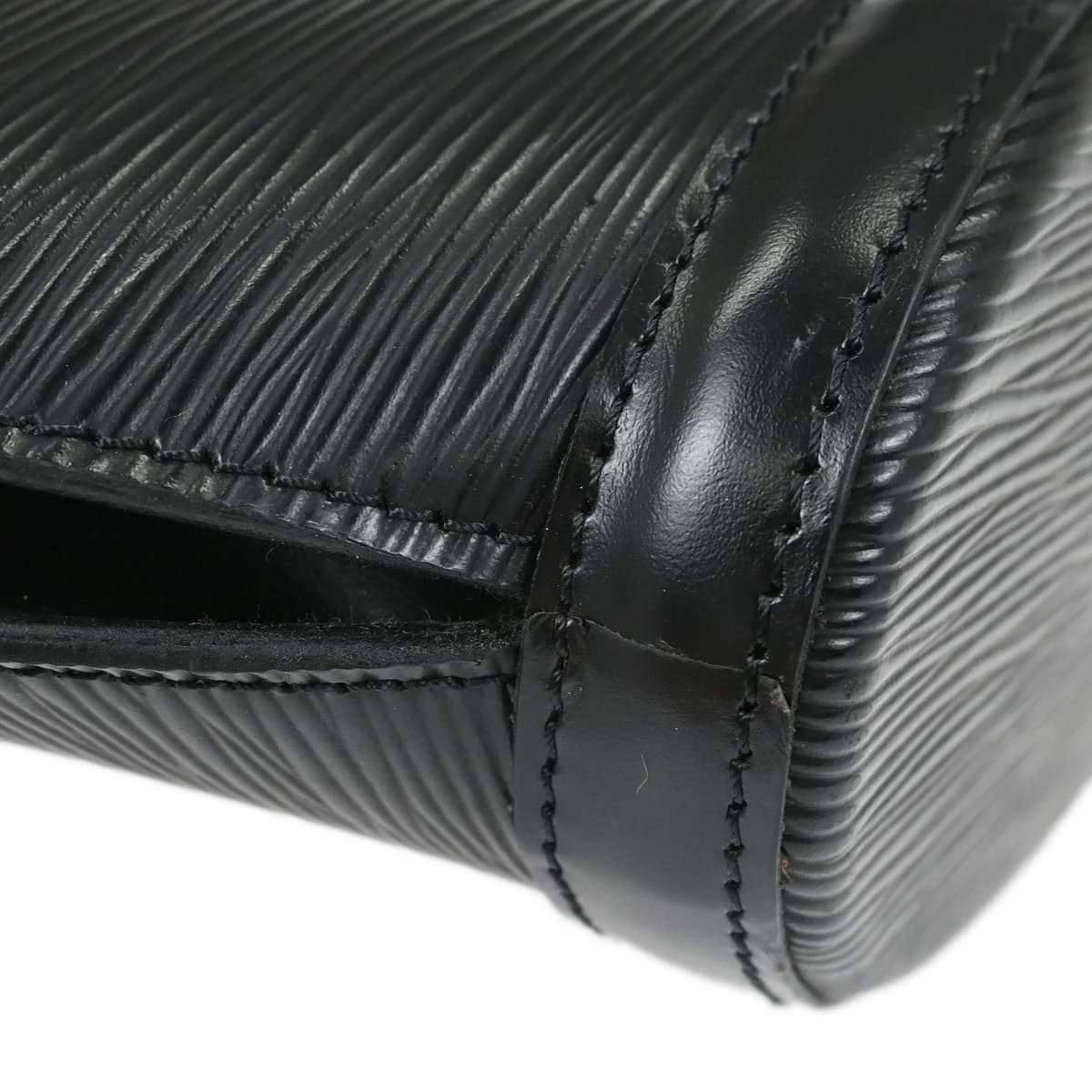Black textured leather tote bag with two rolled handles and open top.