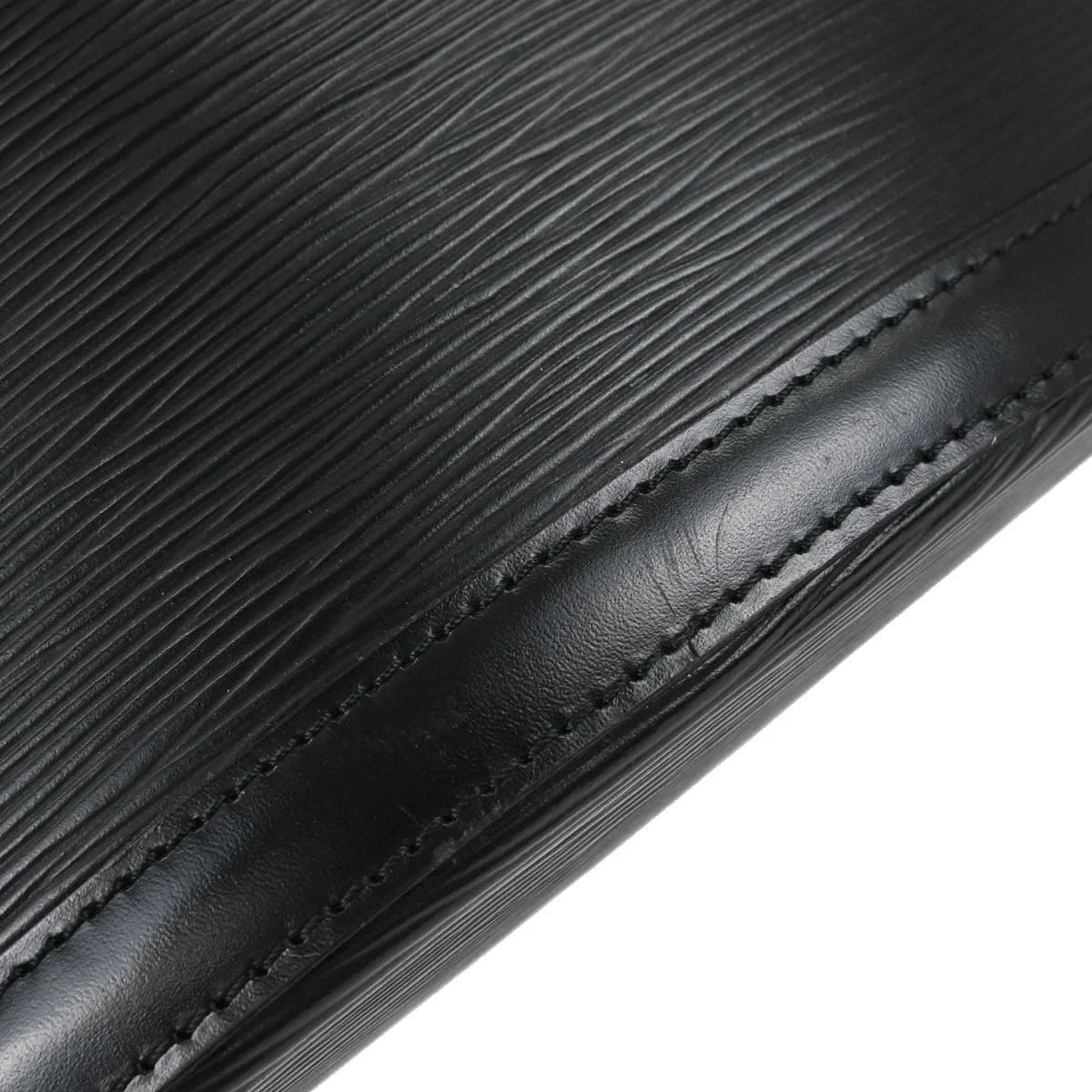 Black textured leather tote bag with two rolled handles and open top.