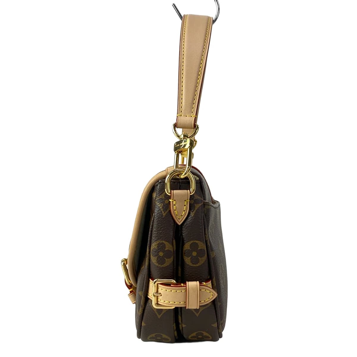 Small monogram-canvas saddle-style bag with a buckled flap and shoulder strap.