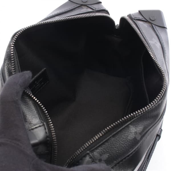 Rigid rectangular black bag with tonal monogram pattern and a wide strap.
