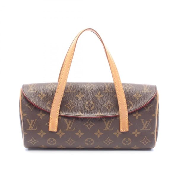 Small brown monogram-pattern coated canvas handbag with a short rolled handle and front flap.