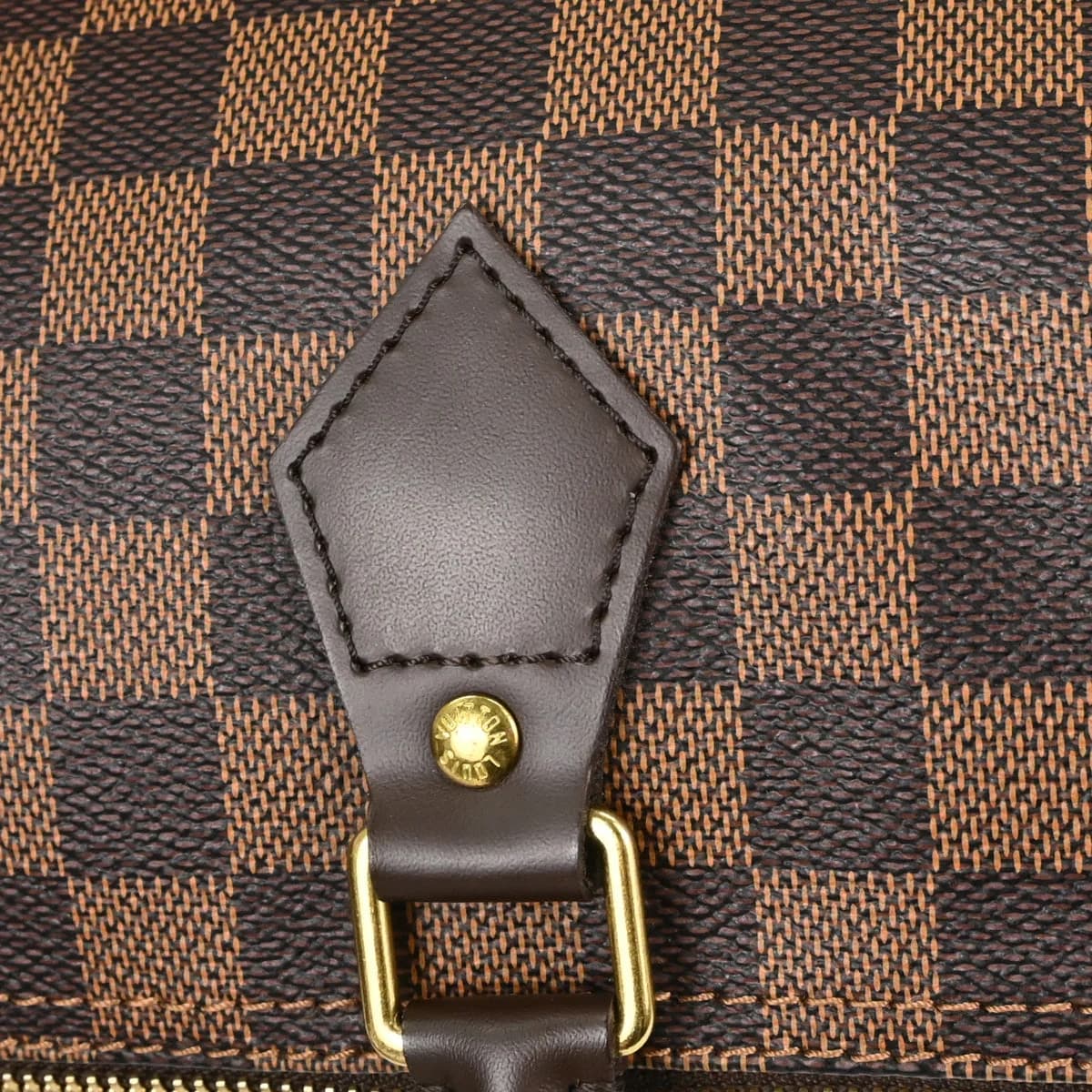 Rounded brown checked canvas handbag with two rolled handles and a zip top.