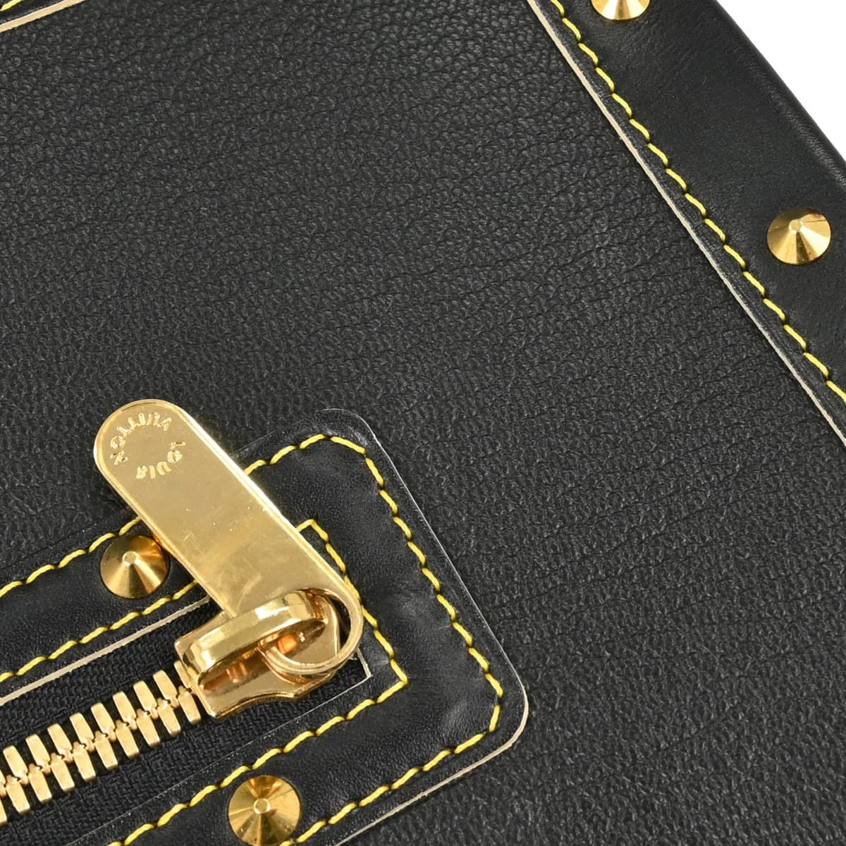 Black textured leather handbag with rolled handles and polished hardware.