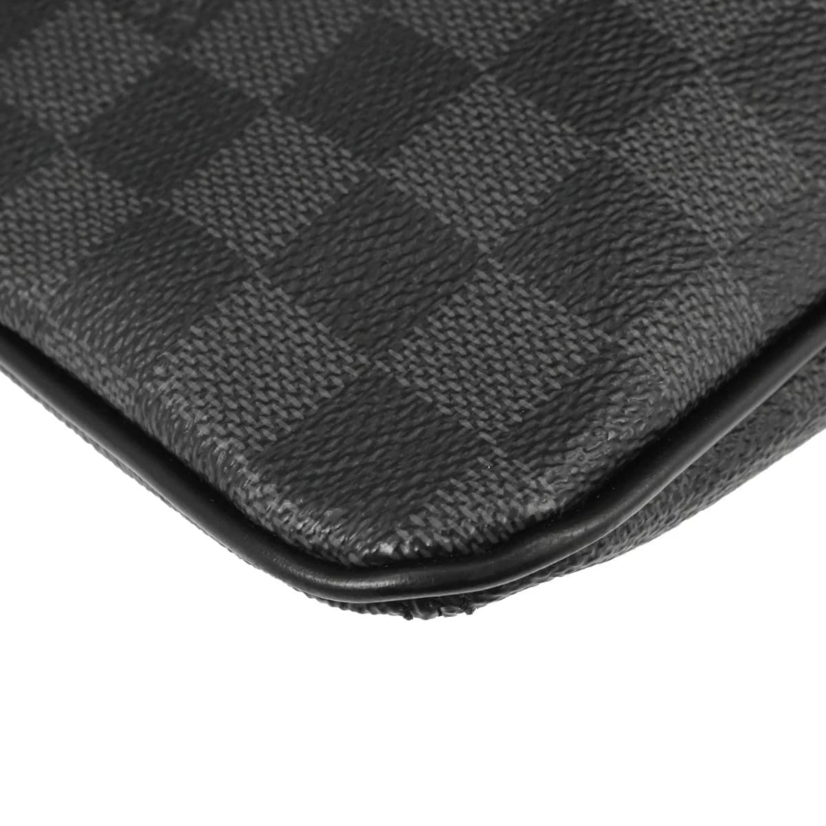Small black and grey checked canvas crossbody bag with a long adjustable strap.