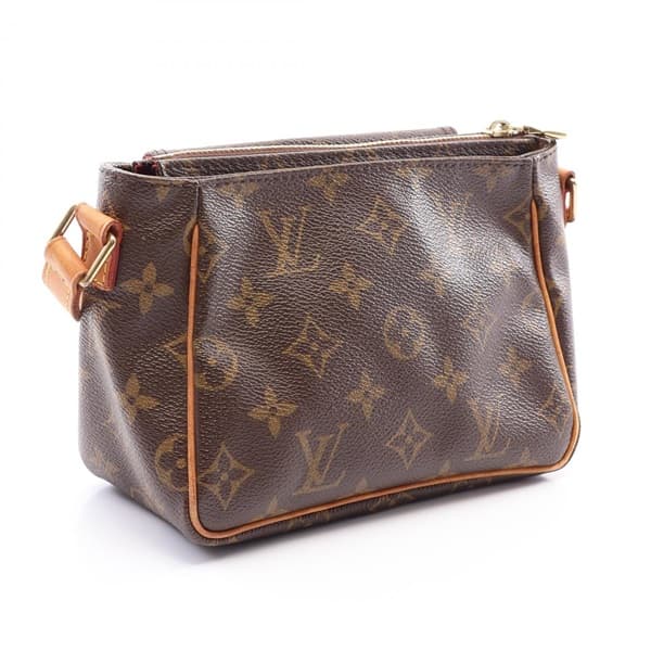 Small brown monogram shoulder bag with curved top and single strap.