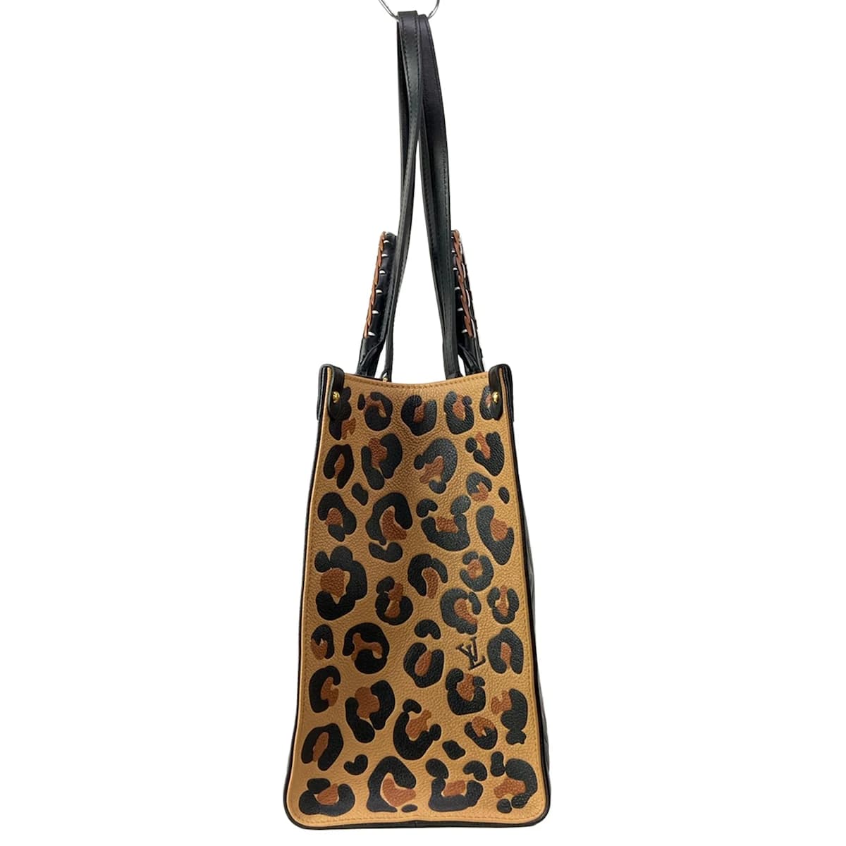 Large two-tone patterned tote with twin top handles and an open top.