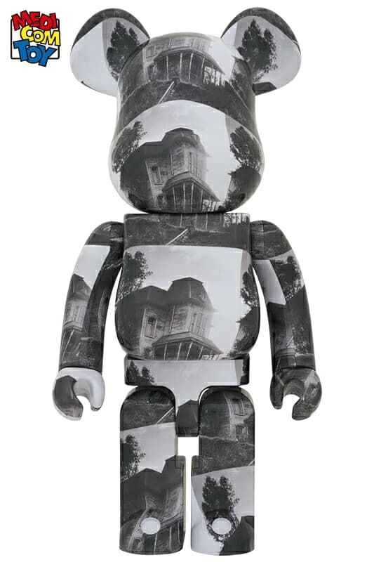 Large bear-shaped collectible figure standing upright with printed house artwork on the body.