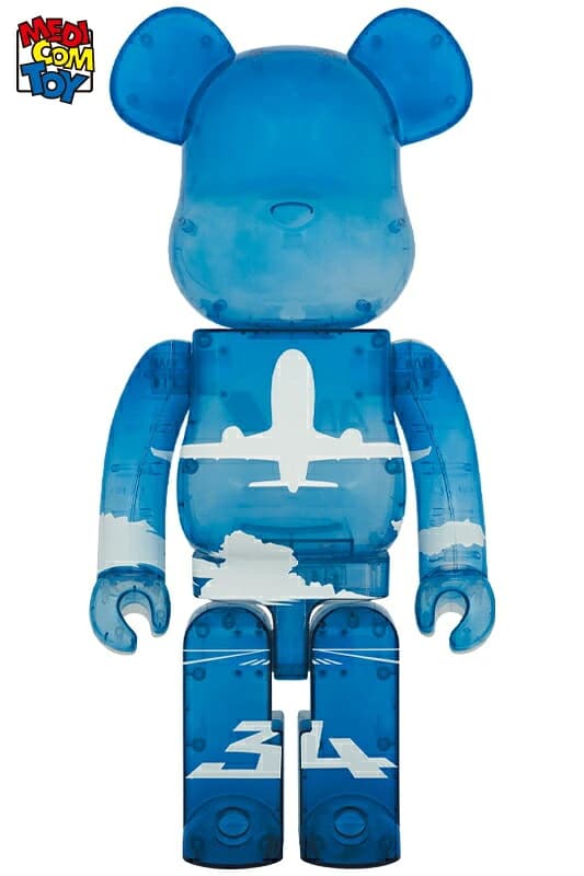Large bear-shaped collectible figure in blue and white with aircraft-themed graphics.