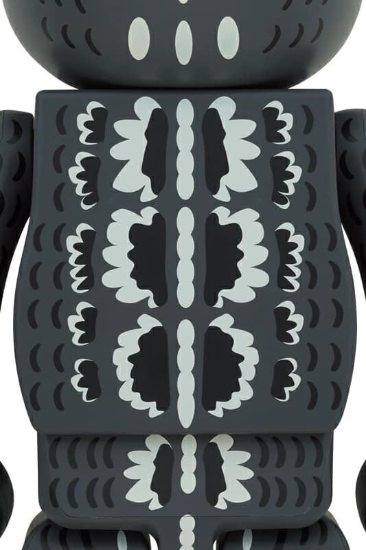 Large bear-shaped collectible figure decorated with dark scaled monster artwork.