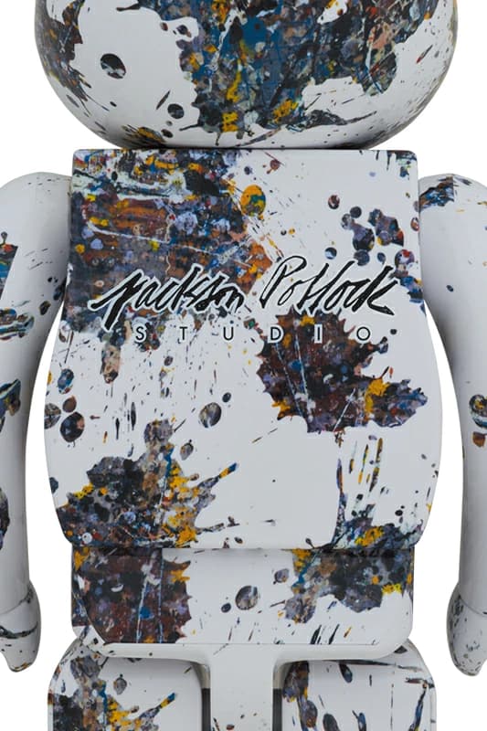 Large bear-shaped collectible figure covered in splattered paint markings