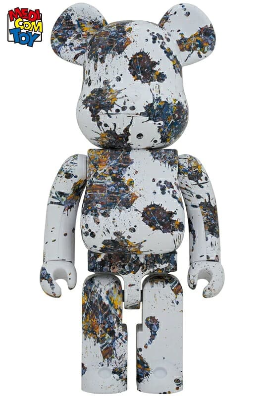 Large bear-shaped collectible figure covered in splattered paint markings