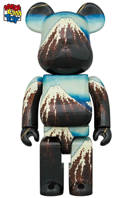 Large bear-shaped figure printed all over with a woodblock print of a mountain under a dark sky.