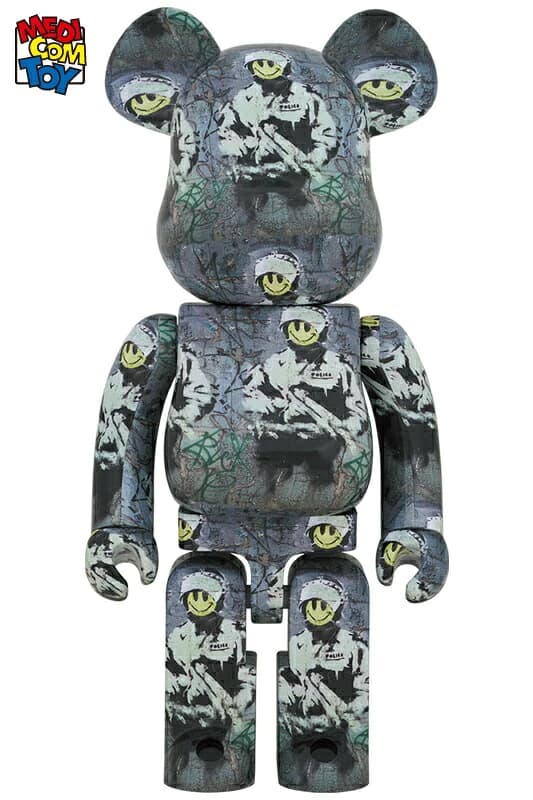 Tall bear-shaped figure decorated as a riot officer with helmet, visor and shield motifs.