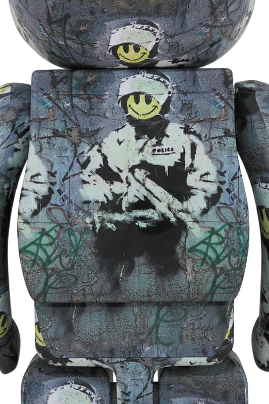 Tall bear-shaped figure decorated as a riot officer with helmet, visor and shield motifs.